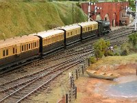 IMG 3493  ... and a rake of 4-wheel early era coaches is arriving from Uley Road and crossing over to the main platform.