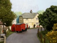 S&D 22  A typical village scene with the Royal Mail van driver picking up the previous nights post, as the village postman starts his rounds for the day.