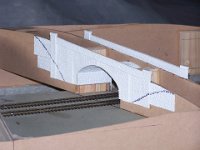 Photo 8 Photo 11  The stone arch bridge spanning Bakewell’s station platforms was an intricate affair, with the road set at an angle to the track and also on a gradient! Langley Models came to the rescue, with a vacuum-formed styrene stone profile kit that was exactly what was needed. Photo 8 shows the kit installed over 6mm MDF formers. The Texta marks on either side show where the lie of the land will be.
